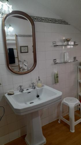 a bathroom with a white sink and a mirror at Casa Amarela in Esmoriz