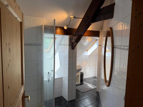 a bathroom with a shower and a glass door at Haus Waldesruh in Nettetal