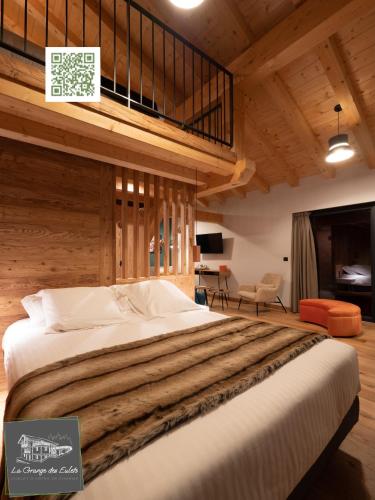 a bedroom with a large bed in a room at La Grange des Eulets in Bourg-Saint-Maurice