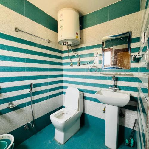 a bathroom with a toilet and a sink at Supreme Lake in Srinagar