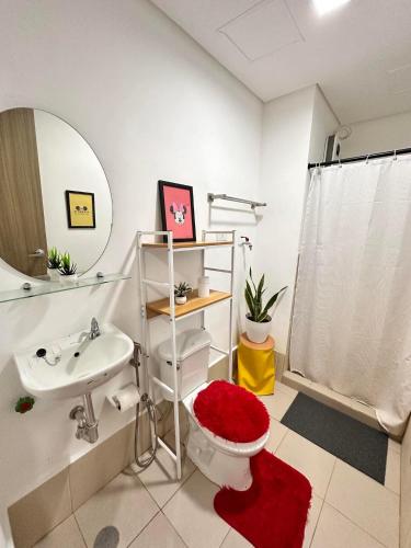 a bathroom with a toilet and a sink and a mirror at HOPE RESIDENCES UNIT 606 building D in Trece Martires
