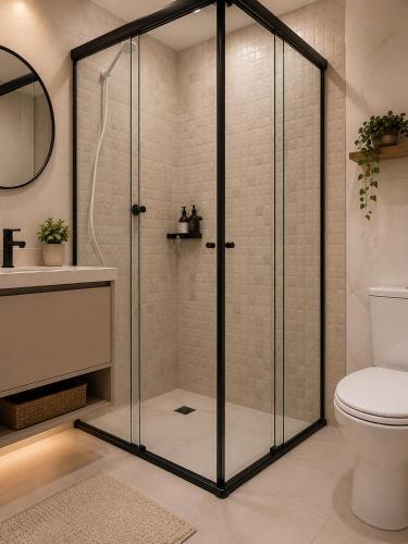 a shower with a glass door in a bathroom at kitnets Luz Beira mar in Tramandaí