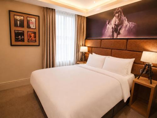 a bedroom with a large white bed in a room at The Residence Hotel in Galway