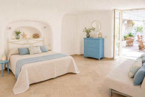 a bedroom with a bed and a blue dresser at Maridea - Il Paradiso sulla Baia in Ponza