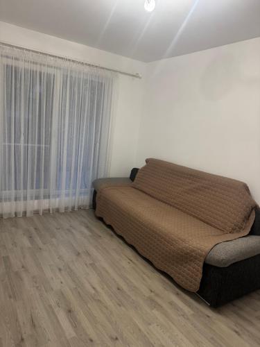 a bedroom with a bed and a large window at Otopeni Maramures in Otopeni