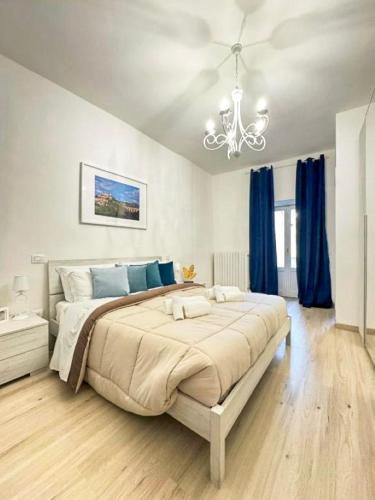 a bedroom with a large bed with blue curtains at Palazzo Monterone Apartments in Spoleto