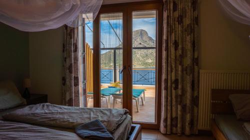 a bedroom with a view of a balcony with a table at Casa Sabine in Masouri