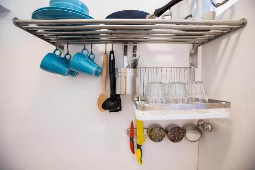 a kitchen rack with utensils on a wall at Center eazZynight 2 in Zagreb