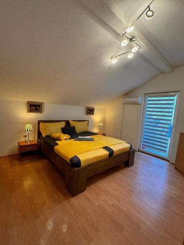 a bedroom with a large bed in a room at Kuća za odmor Aiman in Mahala