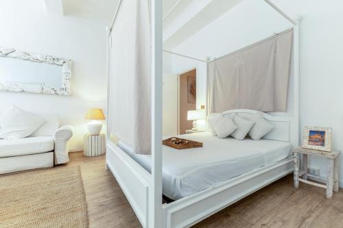 a bedroom with a white bed and a mirror at Piazza di Spagna Historic Flat in Rome