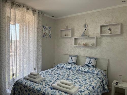 a bedroom with a bed with towels on it at Il BORGO in Lapedona