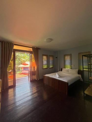 a bedroom with a large bed and a balcony at Amber Koh Rong in Koh Rong Island