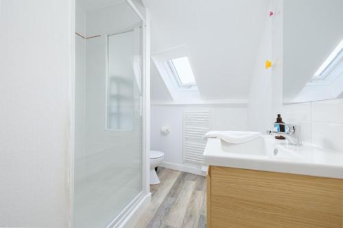 a bathroom with a shower and a sink and a toilet at Le Triplex du Vœu Spacious Apartment in Cherbourg en Cotentin