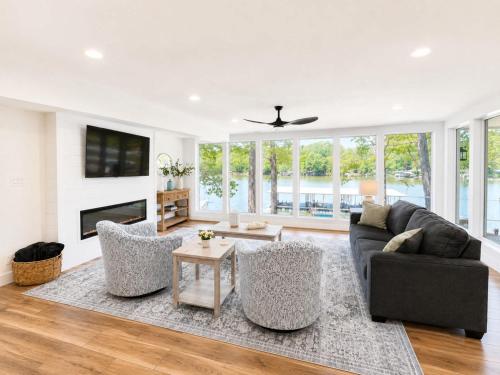 a living room with a couch and chairs at The Ozark Acre 6BDR Lakefront in Sunrise Beach