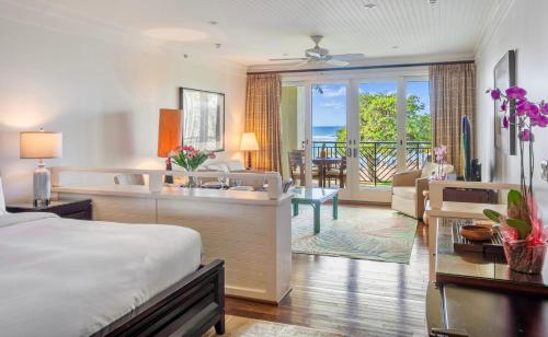 a hotel room with a bed and a living room at Villa 202 at Turtle Bay in Kahuku