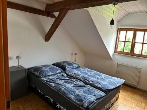 a bedroom with a large bed in a attic at Tiny House mit Terrasse nahe dem Bodensee in Wahlwies