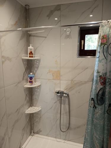 a bathroom with a shower with a shower curtain at Thea Panorama in Makri