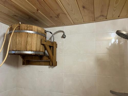 a bathroom with a shower with a bucket on the wall at Welcome to Карпати in Skole