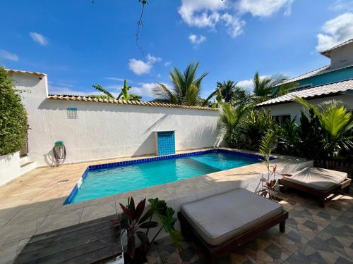 a swimming pool in the backyard of a house at Renascer Suites in Búzios