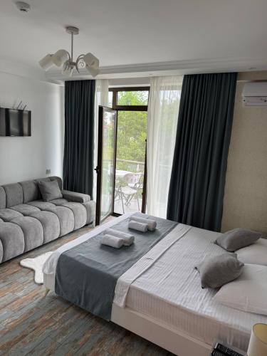 a bedroom with a large bed and a large window at White-House in Ureki