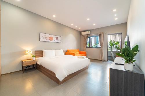 a bedroom with a large bed and an orange couch at 5BR Home - BBQ - City Centre - Free Pick Up for 3 nights in Ho Chi Minh City