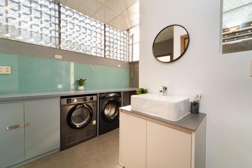 a bathroom with a sink and a washing machine at 5BR Home - BBQ - City Centre - Free Pick Up for 3 nights in Ho Chi Minh City