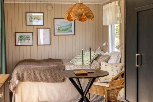 a bedroom with a bed with a table in it at The Floating Lodge in Linköping