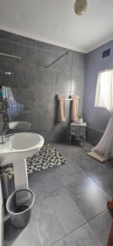 a bathroom with a sink and a mirror at GerSan Oasis in Nigel