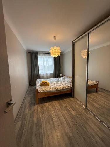 a bedroom with a bed and a large mirror at Gallo Riga Apartments in Riga