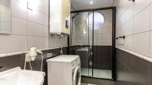 a bathroom with a washing machine and a sink at Villa Aurora in Petrovac na Moru