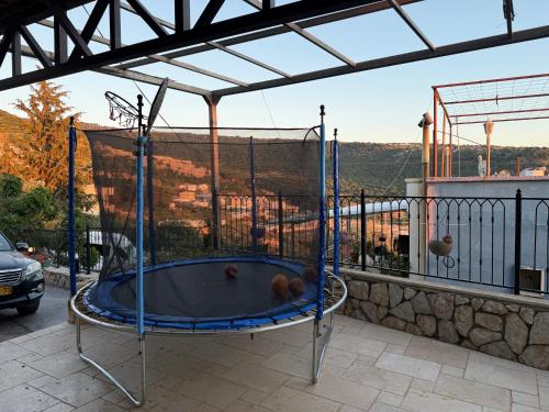 a trampoline on a balcony with a view at The Sky Zimmer in Ein Kinya