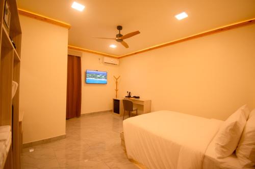 a hotel room with a bed and a desk at Maako Retreats in Milandu