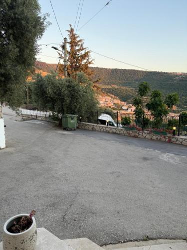 an empty street with a pot on the side of the road at The Sky Zimmer in Ein Kinya