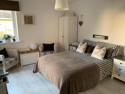 a bedroom with a bed and a chair at Country house in Svidník