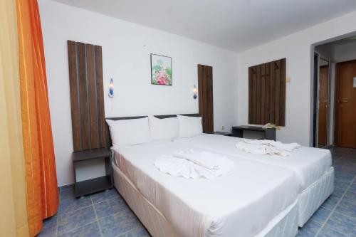 a bedroom with a large white bed in a room at Hotel Arsenal in Nesebar