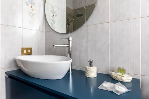 a bathroom with a large white sink on a blue counter at Casa Orlando in Modena