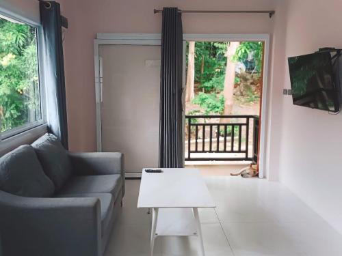 a living room with a couch and a table at Elevated Bungalow House 3-11 in Nathon Bay