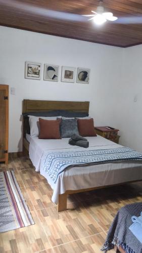 a bedroom with a large bed in a room at Casa Águas do Céu de Lumiar in Nova Friburgo