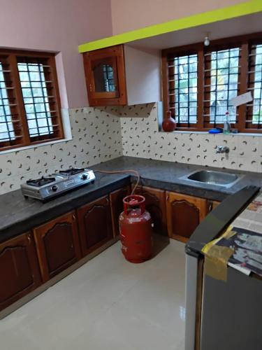 a kitchen with a fire hydrant in the middle of it at AS Villa Homestay in Varkala