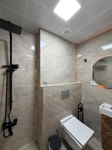 a small bathroom with a toilet and a shower at Mardin Kent Suit Hotel in Mardin
