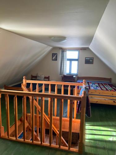 a bedroom with a bed and a wooden railing at Dębowy Zakątek in Dębowo