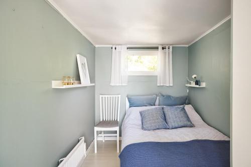 a small bedroom with a bed and a window at Sea View cottage with 2 sleeping cabins in Uddevalla