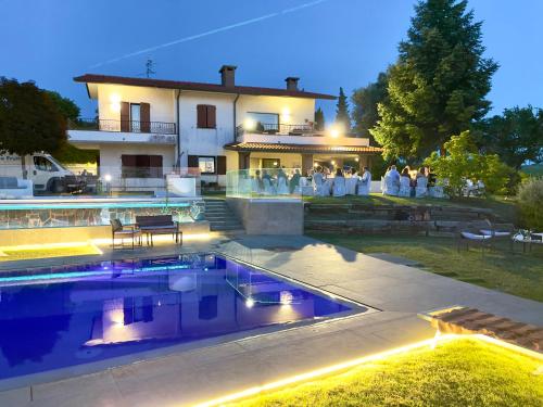 a house with a swimming pool in front of it at Il Sentiero dei Goti San Marino e Montefeltro in Monte Grimano Terme