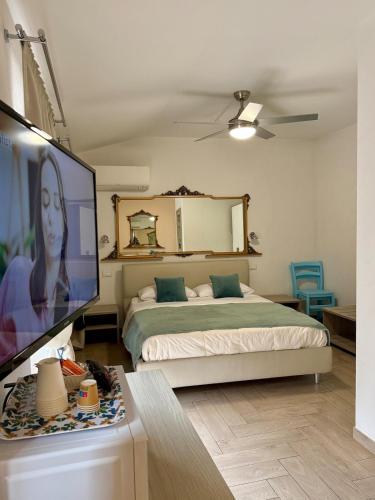 a bedroom with a bed and a flat screen tv at Casa Cavour Garda in Garda