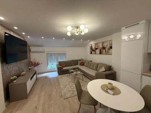 a living room with a couch and a table at Meddy Luxury Apartment in Mostar