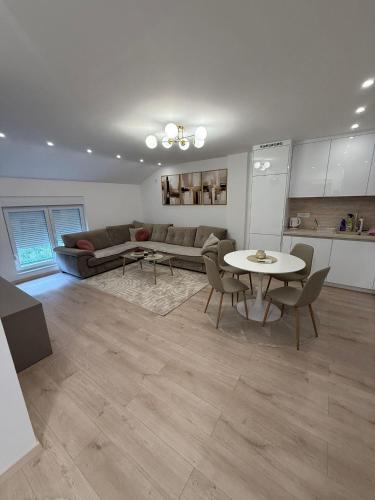 a living room with a couch and a table at Meddy Luxury Apartment in Mostar