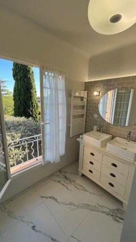 a bathroom with a sink and a mirror and a window at Gîtes et Chambres Atypiques Le Temps des Légendes in Saint-Quentin-la-Poterie