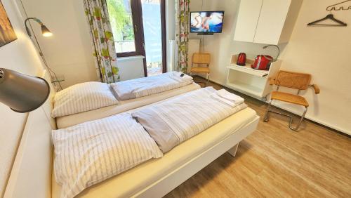 a hospital room with two beds and a television at Aparthotel Marion Weber in Bremen