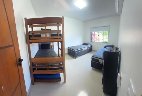 a room with two bunk beds and a bed at Faith Home 1 in Arraial do Cabo