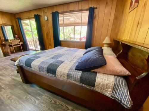 a bedroom with a bed with pillows and a window at Shady Oak in Concan